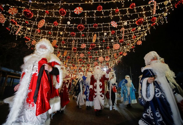 Participants dressed as Ayaz Ata (Father Frost) – the Kazakh equivalent of Santa Claus take part in a procession through city streets while marking the New Year and Christmas season in Almaty, Kazakhstan on December 25, 2023. (Photo by Pavel Mikheyev/Reuters)