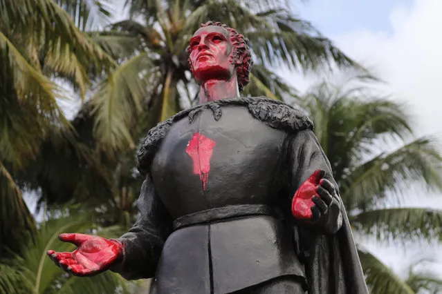A statue of Christopher Columbus is shown vandalized at Bayfront Park in Miami, Thursday, June 11, 2020. Miami police say that several people were arrested for vandalizing the statue of Columbus and Juan Ponce de León during a protest Wednesday. Protests continue over the death of George Floyd, a black man who died  last month while in police custody in Minneapolis. (Photo by Lynne Sladky/AP Photo)