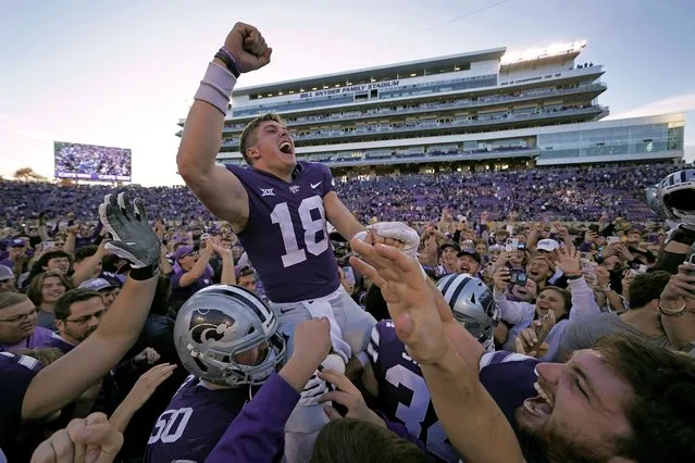 Kansas State quarterback Will Howard (18) celebrates with the crowd as he is carried off the field by teammates after an NCAA college football game against Oklahoma State Saturday, October 29, 2022, in Manhattan, Kan. Kansas State won 48-0. (Photo by Charlie Riedel/AP Photo)