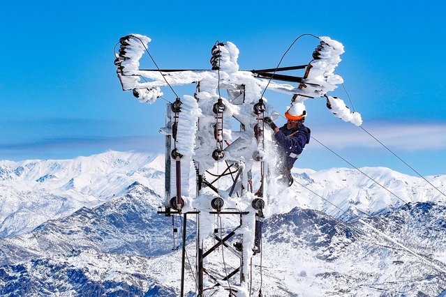 Maintenance teams fix problems occurring in electricity poles covered in snow and ice where harsh winter conditions prevail in Hakkari, Turkiye on February 25, 2025. (Photo by Ozkan Bilgin/Anadolu via Getty Images)