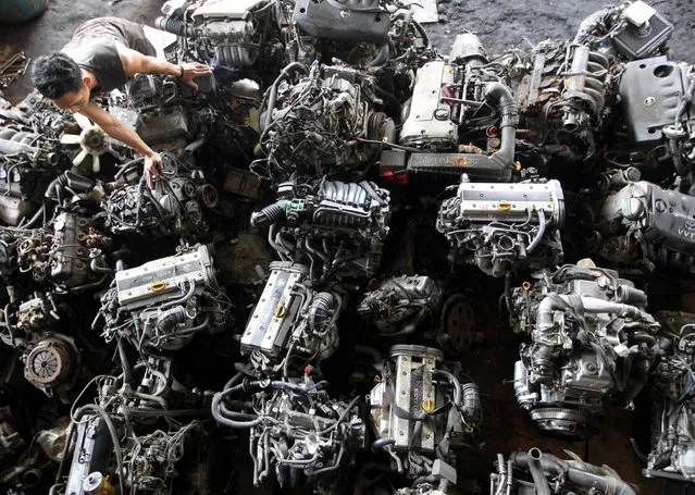 An Indonesian man sorts second hand engine part at a Vriva junk yard in Depok, West Java, Indonesia on October 10, 2014. Developing Asia will remain the fastest-growing region in the world, the Asian Development Bank said. In South-East Asia, the bank cut its gross domestic product growth forecast to 4.6 per cent in 2014, down from a projected 5 per cent in April, with projections trimmed in Indonesia, the Philippines, Singapore, Thailand and Vietnam. (Photo by Bagus Indahono/EPA)