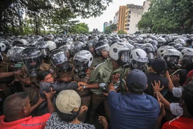 Opposition party supporters clash with police during an anti-government protest march in Colombo, Sri Lanka, 02 November 2022. Thousands of opposition party supporters and opposition lawmakers staged a protest march against the government's crackdown and over the alleged failure to address the worst economic crisis. Protests have been affecting the country for over seven months as Sri Lanka faces its worst-ever economic crisis in decades due to a lack of foreign reserves, resulting in severe shortages in food, fuel, medicine, and imported goods. (Photo by Chamila Karunarathne/EPA/EFE)