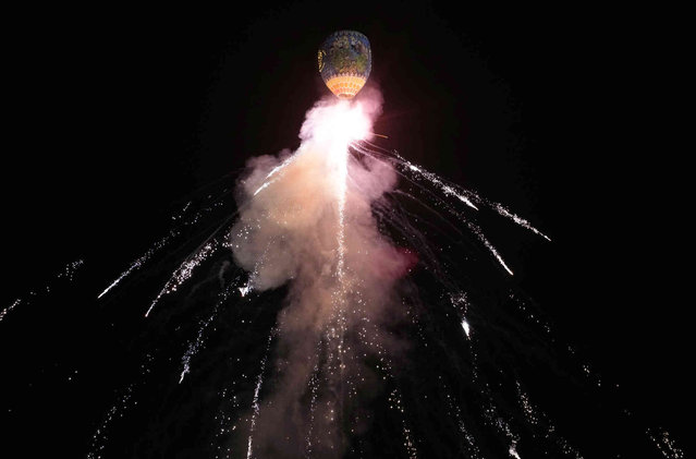 Fireworks are exploded from a hot air balloon during a competition to mark the Tazaungtine lighting festival Thursday, November 14, 2024, in Naypyitaw, Myanmar. (Photo by Aung Shine Oo/AP Photo)