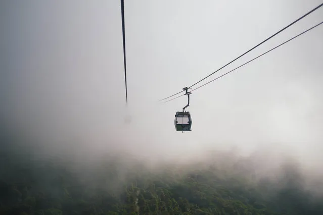 “Journey to the Buddha”. Taking the cable car to see the Big Buddha on cloudy day. Photo location: Ngong Ping, Hong Kong. (Photo and caption by Cynthia Yeung/National Geographic Photo Contest)