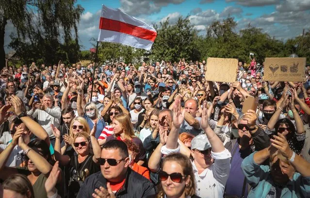 Belarusians attend a meeting in support of Svetlana Tikhanovskaya, candidate for the presidential elections, in Hlybokaje, Belarus, Friday, July 24, 2020. On Friday, 3,000 people turned out at an opposition gathering in Novopolotsk, north of the Belarusian capital. And in the town of Hlybokaje, which has a population of 18,000, more than 1,000 attended Tilkhanovskaya's campaign rally. The presidential election in Belarus is scheduled for August 9, 2020. (Photo by AP Photo/Stringer)