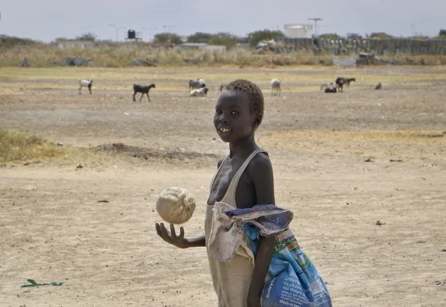 In this photo taken Sunday, December 9, 2018, a boy throws a ball while walking in the United Nations protection of civilians site in Bentiu, South Sudan. (Photo by Sam Mednick/AP Photo)