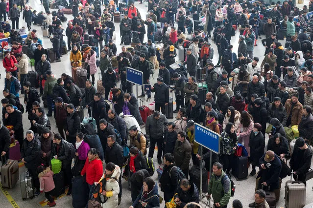 Passengers wait to board trains ahead of the Chinese Lunar New Year, at Nanjing Railway Station in Jiangsu province, China on February 1, 2018. (Photo by Reuters/China Daily)