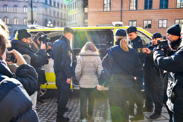 Swedish climate activist Greta Thunberg (C) is led away by police after being arrested during a sit in outside the Swedish parliament, the Riksdagen, to demonstrate for climate action, on March 12, 2024 in Stockholm, Sweden. (Photo by Samuel Steen/TT News Agency via AFP Photo)