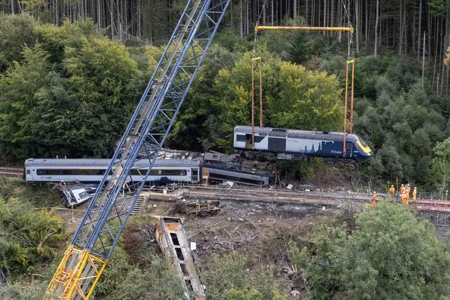 The carriage is lifted by a giant 600 tonne crane from the scene at the train derailment on September 10, 2020 in Stonehaven, Scotland. The train derailed on August 12 after hitting a landslide on the tracks, killing two crew members and a passenger. (Photo by Derek Ironside – Pool/Getty Images)