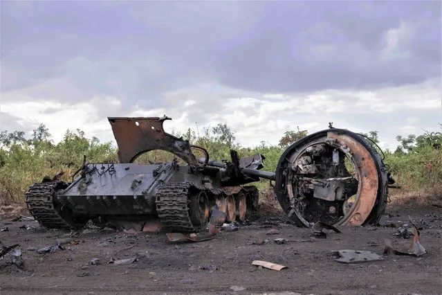 This photograph taken on January 6, 2023 shows a destroyed military vehicle in Rugari, after clashes between the Congolese army and M23 rebels in the east of the Democratic Republic of Congo. (Photo by Guerchom Ndebo/AFP Photo)
