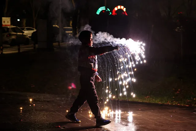 A young boy lets off firecrackers to celebrate the Spring Festival at a community open space January 21, 2023 in Wuhan, Hubei Province, China.China will be marking the Spring Festival which begins with the Lunar New Year on January 22, ushering in the Year of the rabbit. (Photo by Getty Images)