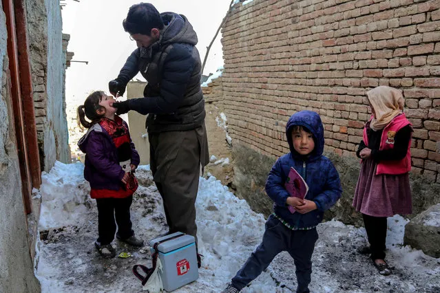 An Afghan health worker administers polio drops to a child during an anti-polio vaccination campaign in Kabul, Afghanistan, 25 January, 2023. According to UNICEF, repeated immunizations have protected millions of children from polio, allowing almost all countries in the world to become polio-free, aside from the two endemic countries of Pakistan and Afghanistan. (Photo by EPA/EFE/Rex Features/Shutterstock)