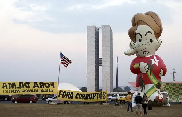 A giant inflatable doll depicting Brazil's President Dilma Rousseff is pictured during a protest against Rousseff in front of the National Congress in Brasilia, Brazil October 21, 2015. Opposition lawyers filed a new petition to Congress for the impeachment of President Dilma Rousseff on Wednesday, seeking to unseat the unpopular leftist leader for allegedly continuing to doctor government accounts into her second term. (Photo by Adriano Machado/Reuters)