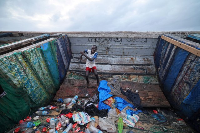 A boy dances inside a pirogue, which was reportedly carrying migrants from Gambia en route to Spain according to local news reports, beached on Malibu Plage after encountering problems offshore, in Dakar, Senegal, on July 1, 2025. (Photo by Zohra Bensemra/Reuters)