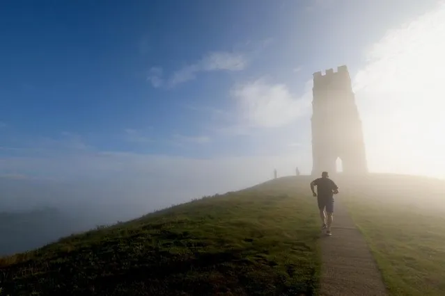 Glastonbury Tor in the English county of Somerset was shrouded in heavy fog on August 17, 2020, giving an early glimpse of autumn. (Photo by David Sims/Splash News and Pictures)