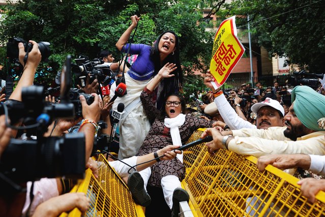 Indian opposition lawmakers shout slogans as they try to cross a police barricade during a protest against what they say are electoral malpractices, in New Delhi, India on August 11, 2025. (Photo by Adnan Abidi/Reuters)