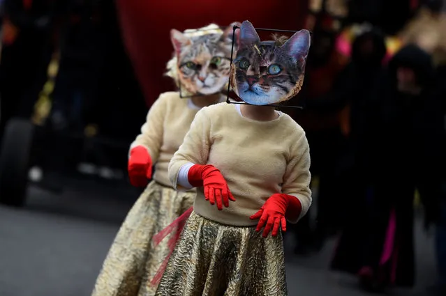 Participants wear cat masks during the St. Patrick's Day parade in Dublin, Ireland on March 17, 2018. (Photo by Clodagh Kilcoyne/Reuters)