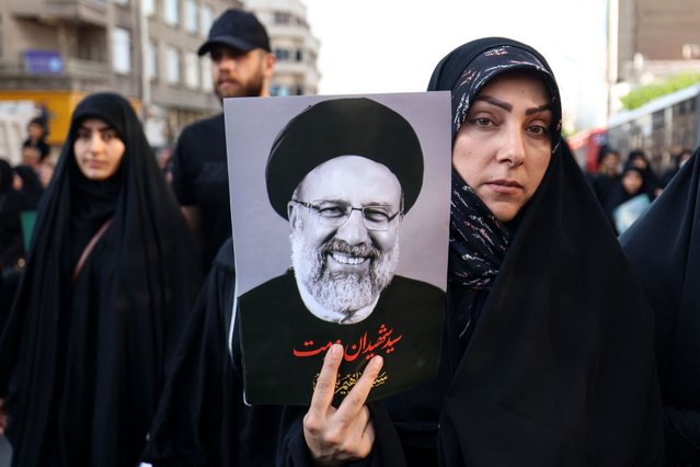 Mourners attend the funeral of Iran's President Ebrahim Raisi, in Tehran on May 22, 2024. Huge crowds of Iranians thronged the streets of the capital Tehran on May 22 for the funeral procession of president Ebrahim Raisi and his entourage, who died in a helicopter crash. (Photo by Atta Kenare/AFP Photo)