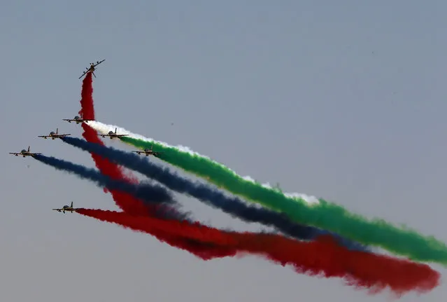 Al-Fursan aerobatics team of the United Arab Emirates Air Force performs at the Dubai Airshow on November 8, 2015. Dubai Airshow took off today to a slow start amid little expectations of major orders to match the multi-billion-dollar sales generated at the last edition of the biennial fair. (Photo by Marwan Naamani/AFP Photo)