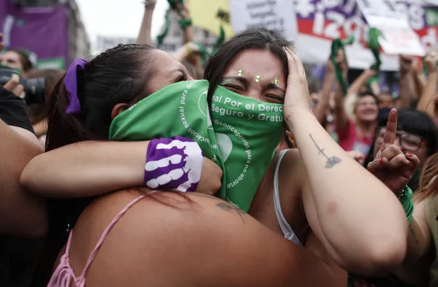 Abortion-rights activists celebrate as Argentine lower house approves a bill that would legalize abortion outside Congress in Buenos Aires, Argentina, Friday, December 11, 2020. The bill now moves to the Senate. (Photo by Natacha Pisarenko/AP Photo)
