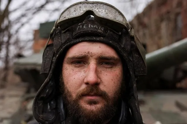 Ukrainian tank unit crew member, call sign “Mehan”, poses for a portrait after returning from a mission at the frontline, amid Russia's invasion of Ukraine, near the bombed-out eastern Ukrainian city of Bakhmut, in the eastern Donetsk region, Ukraine on March 29, 2023. (Photo by Violeta Santos Moura/Reuters)
