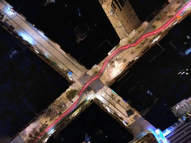 An aerial view of a road, which was painted with red and pink stripes symbolizing freedom to protest the Israeli government plan to introduce judicial changes, seen by the opposition as an attempt to reduce the powers of the judicial authority in favor of the executive authority, to the high court in Jerusalem on March 16, 2023. (Photo by Amir Goldstein/Anadolu Agency via Getty Images)