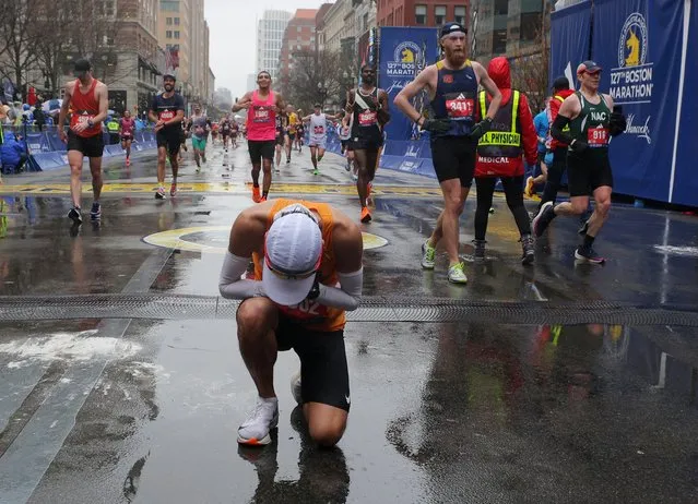 Kevin Hii reacts at the finish line after completing the the the 127th Boston Marathon in Boston, Massachusetts, U.S. on April 17, 2023. (Photo by Brian Snyder/Reuters)