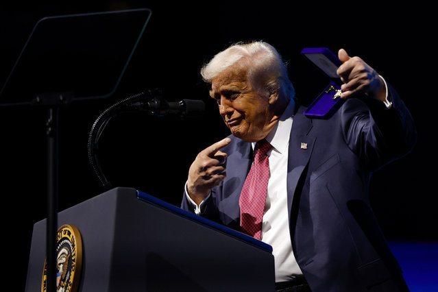 U.S. President Donald Trump displays a key to the city from Miami Mayor Francis Suarez as he speaks during the America Business Forum at the Kaseya Center on November 05, 2025 in Miami, Florida. The forum brings together global leaders, cultural figures and innovators from various sectors for discussions on business, technology and social development. (Photo by Kevin Dietsch/Getty Images)