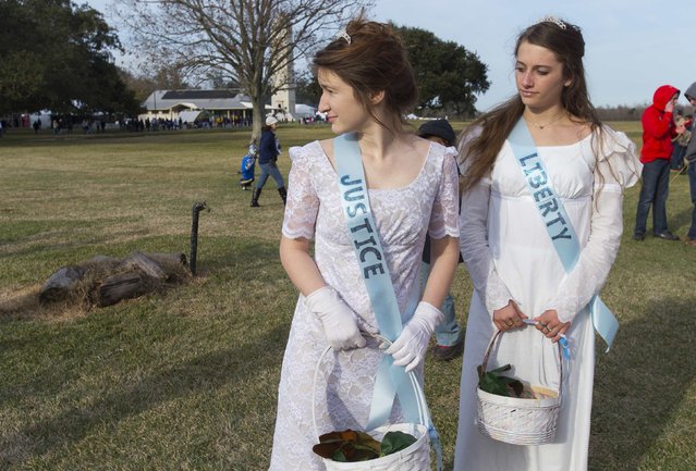 Joanna Jones (L) and Laura Nunez wear banners saying “Justice” and “Liberty” during a commemoration of the Battle of New Orleans in the War of 1812, marking its bicentennial in Chalmette, Louisiana  January 10, 2015. (Photo by Lee Celano/Reuters)