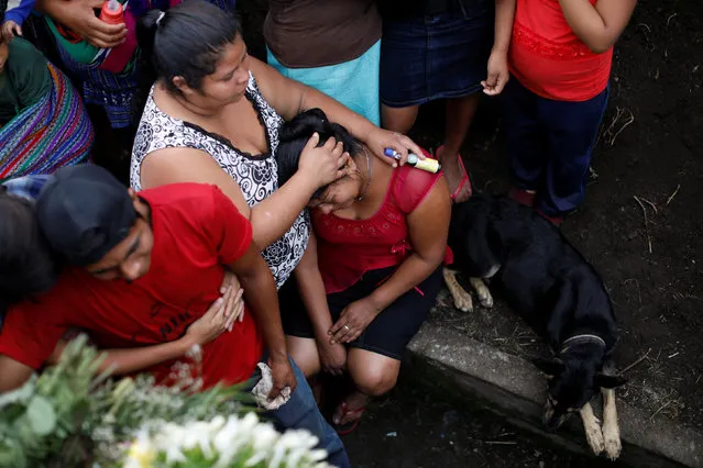 Relatives of Eric Rivas, 20, who died during the eruption of the Fuego volcano, mourn during his funeral in Alotenango, Guatemala on June 6, 2018. (Photo by Jose Cabezas/Reuters)