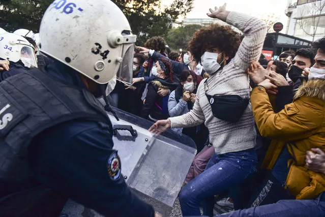 Police in riot gear clash with students of Bogazici University, in Istanbul, Monday, January 4, 2021. Turkish police on Monday clashed with hundreds of students protesting President Recep Tayyip Erdogan's appointment of a figure with ties to his ruling party as rector to one of Turkey's most prestigious universities. (Photo by Zeynep Kuray/AP Photo)