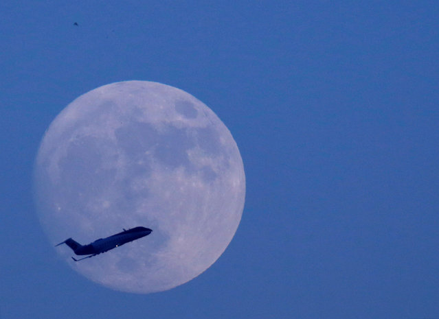 A plane flies past the moon a day before the “supermoon” spectacle in Kathmandu, Nepal November 13, 2016. (Photo by Navesh Chitrakar/Reuters)