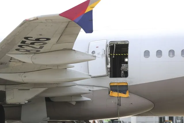 An Asiana Airlines plane is parked as one of the plane's doors suddenly opened at Daegu International Airport in Daegu, South Korea, Friday, May 26, 2023. A passenger opened a door on an Asiana Airlines flight that later landed safely at a South Korean airport Friday, airline and government officials said. (Photo by Yun Kwan-shick/Yonhap via AP Photo)