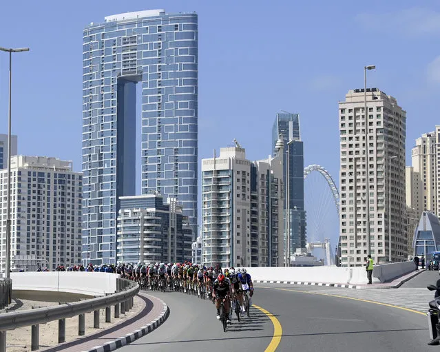 The pack pedal during the sixth stage of the UAE tour cycling race, from Deira Islands to Palm Jumeriah, Dubai, United Arab Emirates, Friday, February 26, 2021. (Photo by Fabio Ferrari/LaPresse via AP Photo)