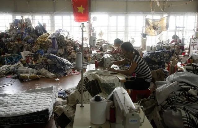 Women work at a factory producing blankets, sheets, pillows and cushions at a village outside Hanoi January 27, 2015. Small enterprises are a vital link in Vietnam's aspirations to become a global manufacturing dynamo as the country gears up to sign a slew of international trade deals, but many of these firms are uncompetitive, poorly managed and sunken by debt. (Photo by Reuters/Kham)