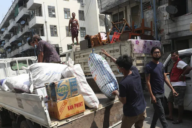 State railway employee load belongings after being evicted from their homes Saturday, March 20, 2021, in Mandalay, Myanmar. State railway workers in Mandalay have been threatened with eviction to force them to end their support for the Civil Disobedience Movement (CDM) against military rule. (Photo by AP Photo/Stringer)