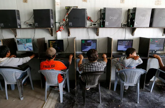 Syrian refugee children play computer games at Zaatari refugee camp near the border with Syria, in Mafraq, Jordan October 15, 2016. (Photo by Ammar Awad/Reuters)