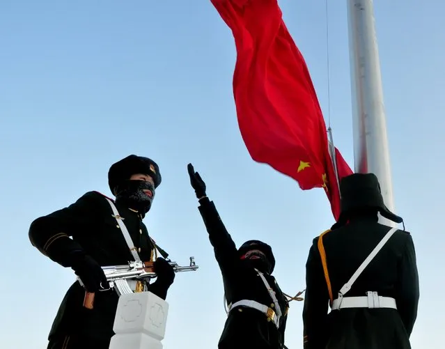 Armed police officers attend a flag-raising ceremony under the temperature of minus 32 degree celsius to celebrate the new year in Greater Khingan Mountains, January 1, 2016, in Mohe, Heilongjiang Province of China. (Photo by ChinaFotoPress/Getty Images)