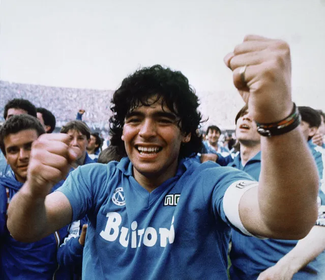 Argentine soccer superstar Diego Armando Maradona cheers after the Napoli team clinched its first Italian major league title in Naples, Italy, on May 10, 1987. Diego Maradona has died. The Argentine soccer great was among the best players ever and who led his country to the 1986 World Cup title before later struggling with cocaine use and obesity. He was 60. (Photo by Massimo Sambucetti/AP Photo/File )