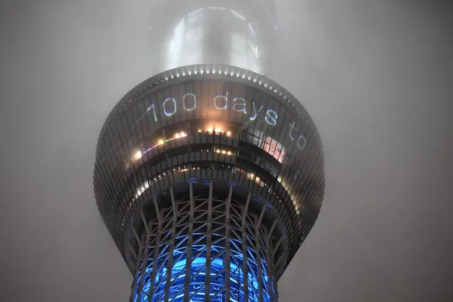 This picture shows the 100 days countdown till the start of the Tokyo 2020 Olympic Games displayed on the illuminated Tokyo Skytree in Tokyo on April 14, 2021. (Photo by Kazuhiro Nogi/AFP Photo)