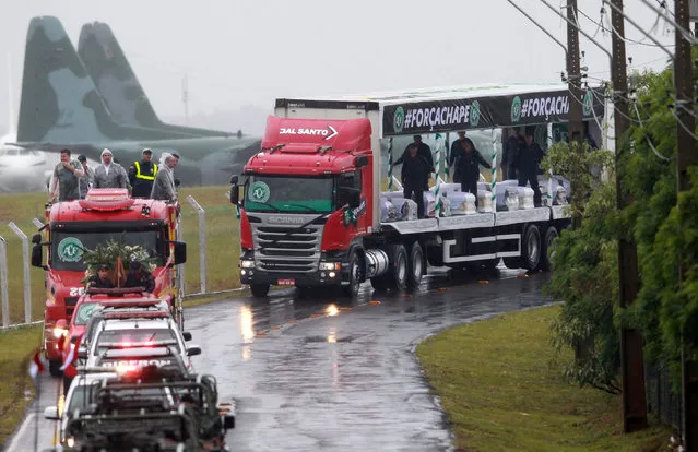 Trucks carrying the coffins of victims of the plane crash in Colombia leave the airport on their way to the Arena Conda stadium in Chapeco, Brazil, December 3, 2016. (Photo by Diego Vara/Reuters)