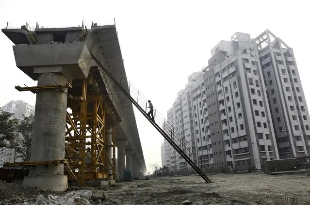 A worker climbs up to a pillar of a metro railway under construction in Kolkata February 9, 2015. Taken at face value India will post robust quarterly growth figures on Monday, but changes in the way Asia's third largest economy is measured has left analysts and the government's own chief economic advisor doubting how far the data can be trusted. (Photo by Rupak De Chowdhuri/Reuters)
