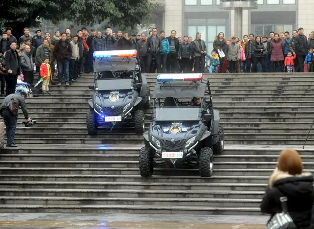 People watch a police force showcase during the debut of new patrolling police vehicles in Chongqing Municipality, China, January 18, 2016. (Photo by Reuters/Stringer)