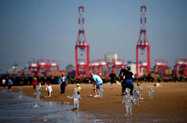 Ice sculptures of children created by Sand in Your Eye to highlight the importance of COP26, the global climate conference, are seen at New Brighton Beach on the Wirral peninsular in New Brighton, Britain on May 31, 2021. (Photo by Jason Cairnduff/Reuters)