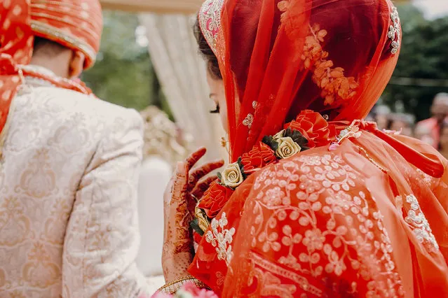 Look from behind at stunning indian bride dressed in red. (Photo by IVASHstudio/Rex Features/Shutterstock)