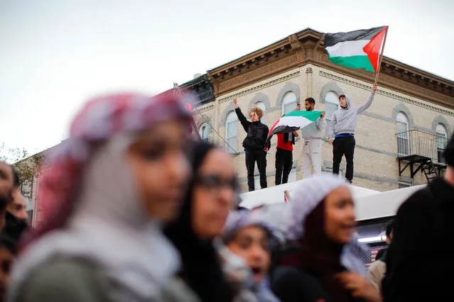 People wave flags during a rally in support of Palestinians in Brooklyn, New York on October 21, 2023, amid ongoing conflict between Israel and Hamas. (Photo by Kena Betancur/AFP Photo)