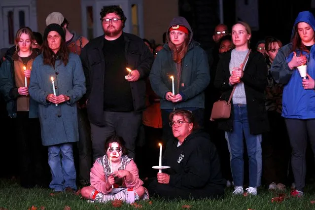 Mourners take part in a vigil for the victims of the deadly mass shooting outside the Basilica of Saints Peter and Paul, in Lewiston, Maine on October 29, 2023. (Photo by Shannon Stapleton/Reuters)
