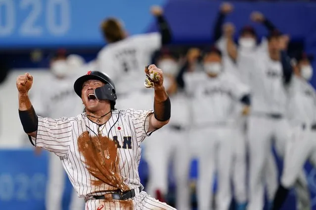 Japan's Takuya Kai reacts after scoring on a three run double by Tetsuto Yamada in the eight inning of a semi-final baseball game against South Korea at the 2020 Summer Olympics, Wednesday, August 4, 2021, in Yokohama, Japan. (Photo by Matt Slocum/AP Photo)