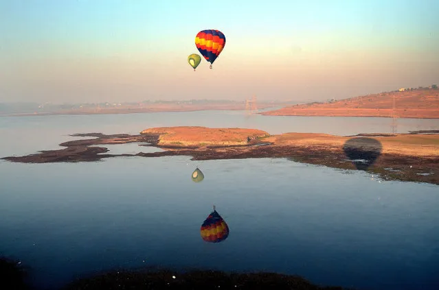 An aerial view from a hot air balloon at balloons flying during the international balloon festival during the month-long “Bhoj Adventure Festival” in Bhopal, India, 13 February 2015. (Photo by Sanjeev Gupta/EPA)