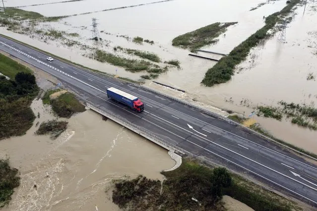 A truck drives through a road after flooding in the Krasnodar region, Russia, Saturday, August 14, 2021. (Photo by AP Photo/Stringer)